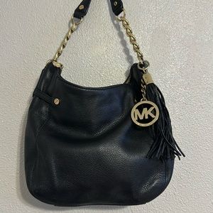Black with gold Michael Kors purse. Still in good condition.